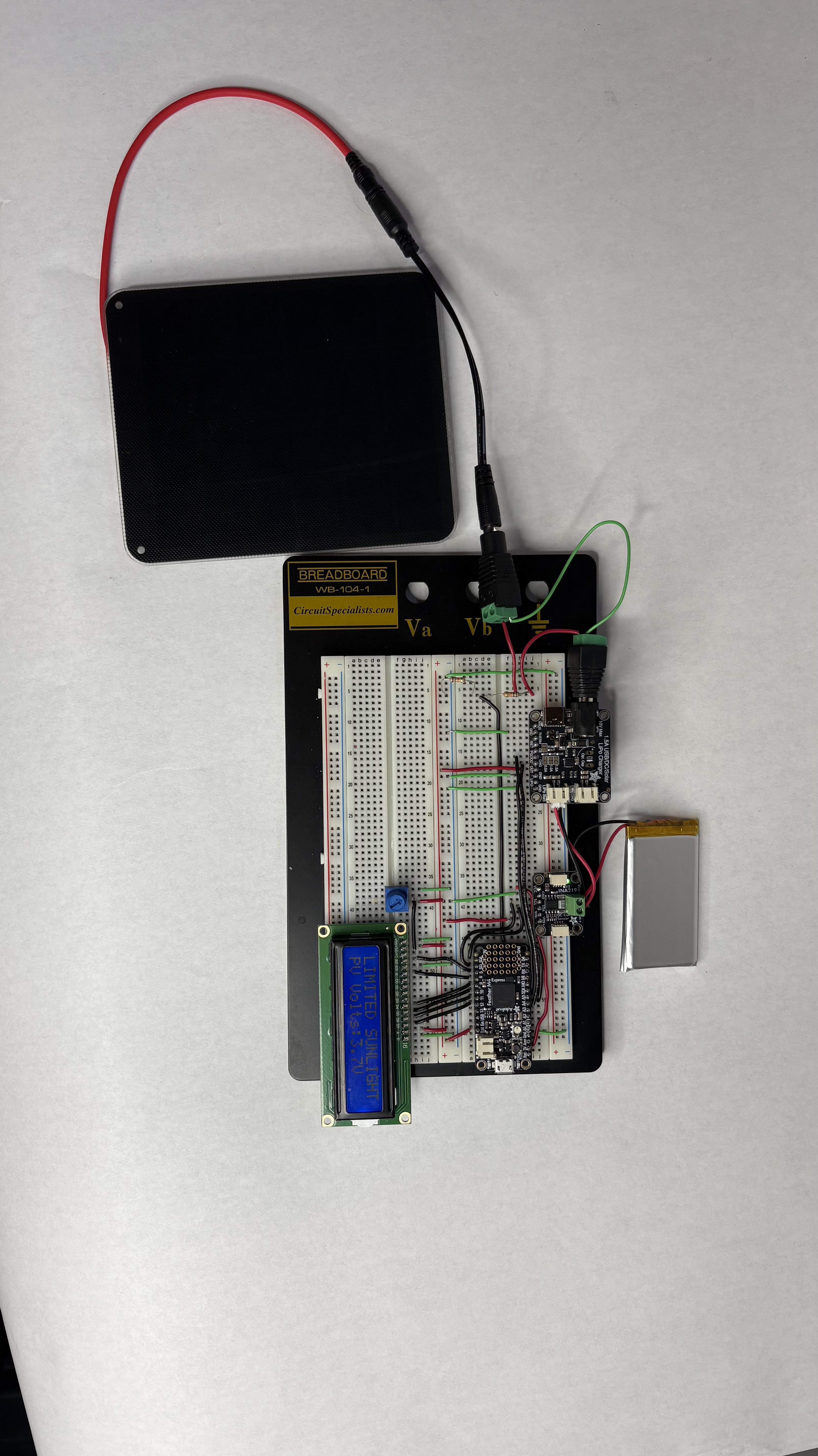 Overall view of the solar panel, breadboard circuit, and battery